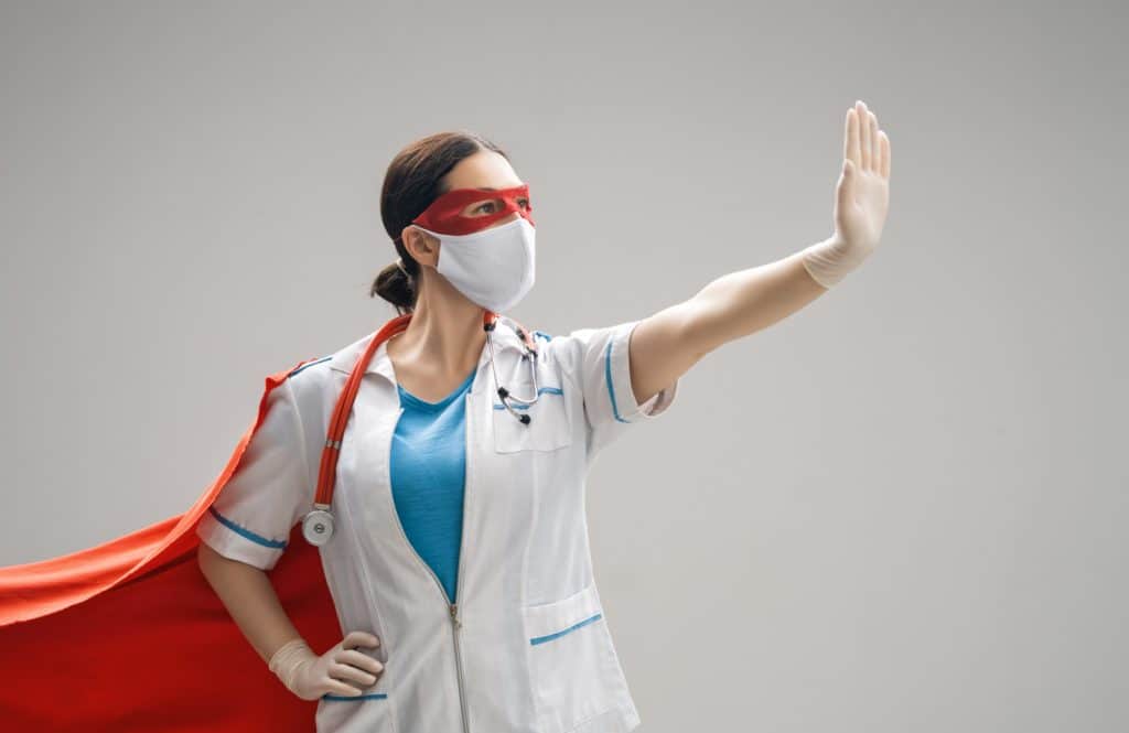 Doctor wearing facemask and superhero cape